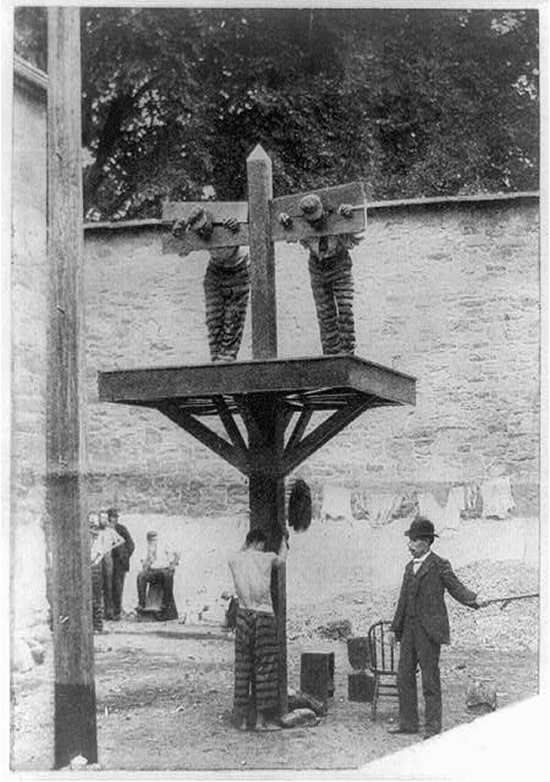 Photograph of two prisoners in a pillory